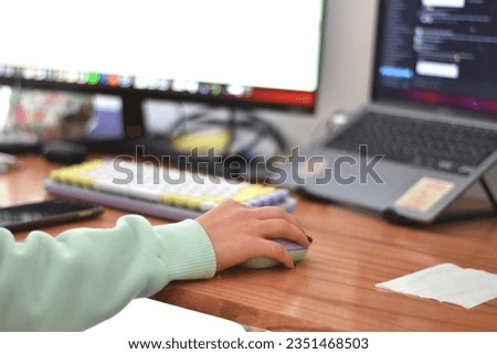 young woman using a lilac-colored mouse and keyboard