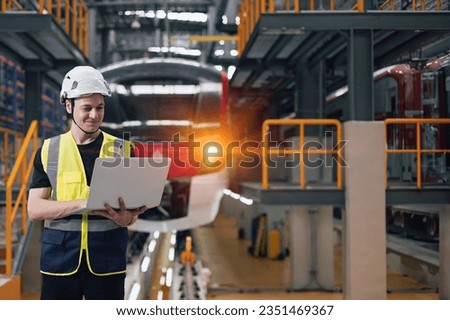 Smart engineer modern electricity train inspector service train locomotive engineering factory, man control monitor railway track in depot of train with laptop computer Royalty-Free Stock Photo #2351469367