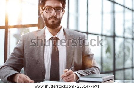 Young businessman signing a contract in the office