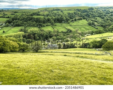 Panoramic landscape, with sloping fields, valley and trees, on a cloudy day in, Shibden Valley, Halifax, UK