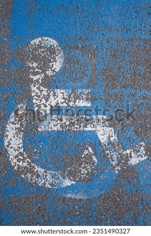 sign on a parking lot space reserved for people with physical disabilities, abstract texture