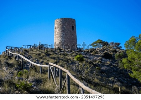 Mediterranean coastal landscape. Historic Torre Vigia De Cerro Gordo, a watchtower looking out for any marauding pirates. La Herradura, Andulasia, Southern Spain Royalty-Free Stock Photo #2351497293