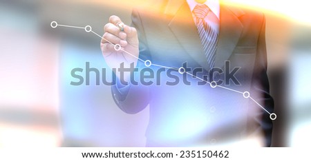 businessman hand writing a business graph 