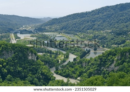 Mountain river valley landscape. Beautiful landscape with river and highway road. Sochi region. Royalty-Free Stock Photo #2351505029