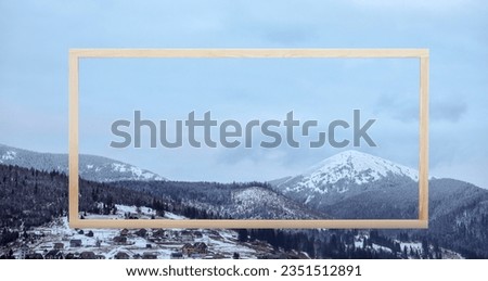 Wooden frame and beautiful mountains covered with snow in winter, banner design