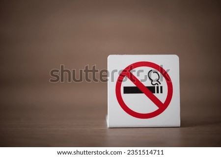 "No smoking" ban sign. Prohibition banner on the table on a brown beige background. Attention, do not smoke.