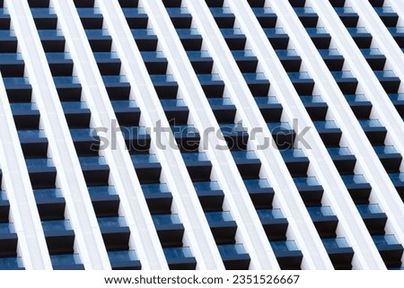 Close-up abstract background with beautiful geometry of windows and balconies of a modern skyscraper.