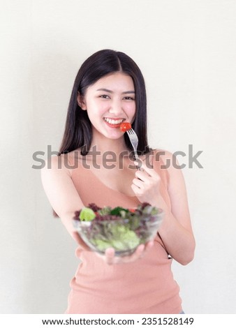 Beautiful beauty woman Asian cute girl feel happy eating diet food fresh salad for good health in the morning , enjoying time in her home white bedroom background - lifestyle beauty woman concept