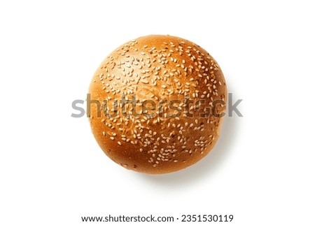Top view shot of a hamburger bread bun, isolated on white background. The freshly baked, golden brown color and a sprinkling of sesame seeds on top. Royalty-Free Stock Photo #2351530119