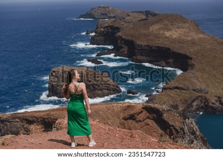 Travelling and exploring Madeira island landscapes and travel destinations. Young female tourist enjoying spectacular Ponta de Sao Lourenco view. Summer tourism by Atlantic  ocean and mountains. 