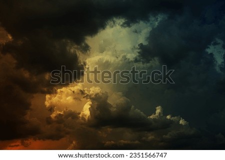 Black dark green blue teal yellow orange red storm clouds. Dramatic ominous night sky background. Hurricane wind cloudy rain lightning glow fire. Epic fantasy mystic. Or war horror apocalypse concept.