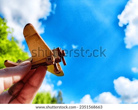 Vintage toy wooden airplane in nature. Private adventure traveling by flight. Aircraft for nature protection, eco friendly, fire extinguishing, rescue of victims. Plane crash and breakdown