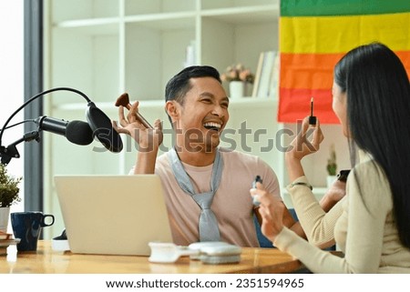 Joyful Asian gay man and friend recording podcast from home studio. Radio, podcasts and blogging concept