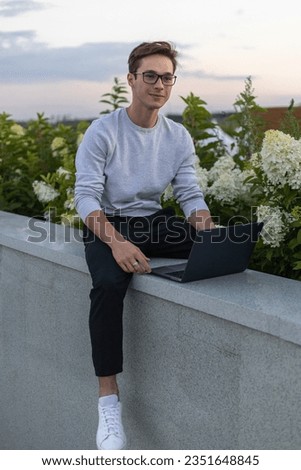 A student is working at a laptop in the park.