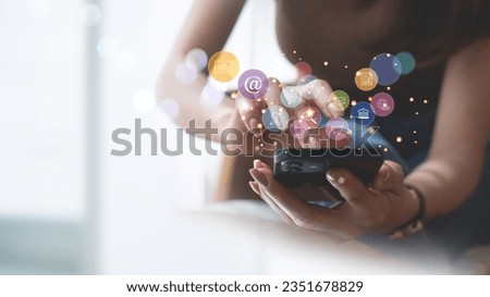 Internet of Things (IoT) technology, Woman using mobile smartphone with E-commerce technology icon on virtual global internet network, Global business, Social media, digital marketing concept. Royalty-Free Stock Photo #2351678829