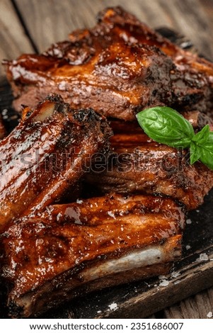 Pork ribs in barbecue sauce. vertical image. top view. place for text. Royalty-Free Stock Photo #2351686007