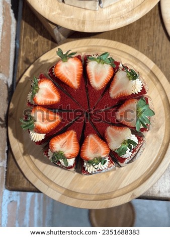 delicious Strawberry cream cheese cake. 
cheesecake on a wooden plate. Fresh  Strawberry topping with cream and thyme leaves. Bakery picture free space for text.