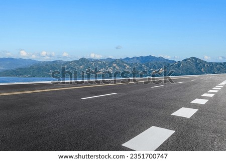 Asphalt highway and sea with mountain natural landscape  Royalty-Free Stock Photo #2351700747
