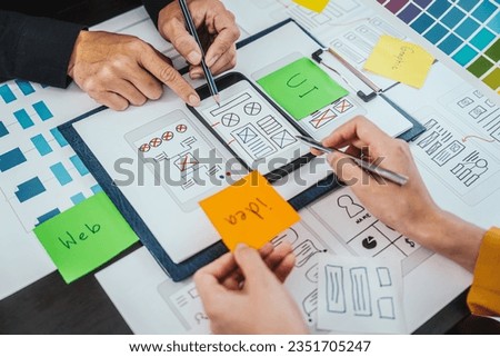 UI, UX designers developers Group team meeting often fill variety of roles in prototyping, product development and adds new ideas to mix, helps set stage for better collaboration during build phase. Royalty-Free Stock Photo #2351705247