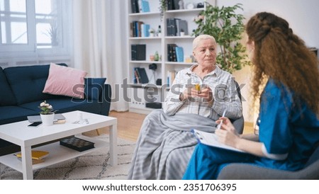 A woman general practitioner explains the dosage of medication to a senior female patient Royalty-Free Stock Photo #2351706395