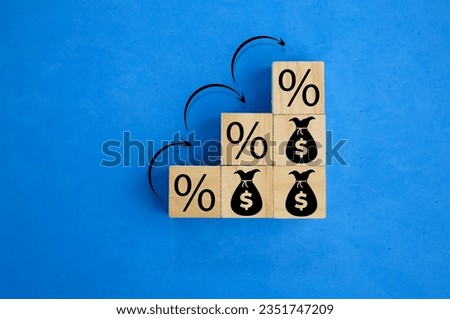 wooden cubes arranged in ascending order with percent and money bag icons. the concept of increasing revenue. return on stocks and mutual funds, long term investment for retirement.