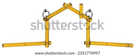 Orange and yellow wooden folding ruler in the shape of a house with steel rings for hanging. Isolated on white background. Photography.