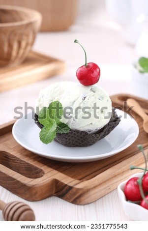 Scoop ice cream in a bowl-shaped waffle container