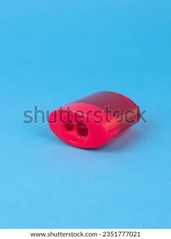 Red Pencil Sharpener Isolated on  blue Background.
