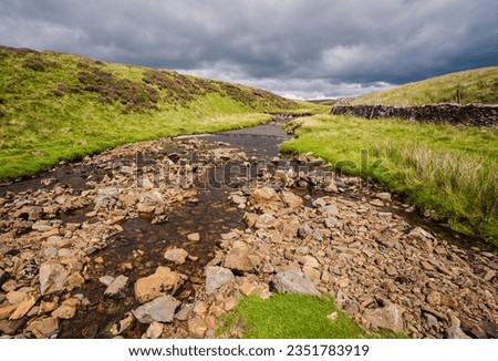 This is the stream that disappears underground very close to Hull Pot in Ribblesdale in the Yorkshire Dales National Park. Royalty-Free Stock Photo #2351783919