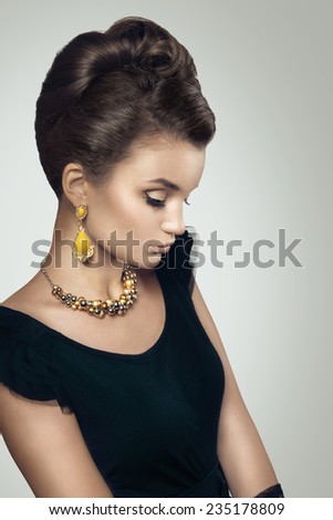 Portrait of beautiful woman with retro grab and old fashioned makeup. Vintage styled photo.