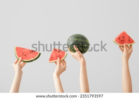 Female hands with pieces of ripe watermelon on white background Royalty-Free Stock Photo #2351793597