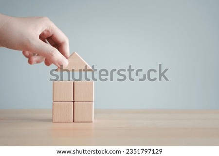 Real estate concept. Select the best home, new home, loan, mortgage, tax, refinance, relocation and plan to get new home with purchase or rent. Hand holding roof house. Decision for choose property. Royalty-Free Stock Photo #2351797129