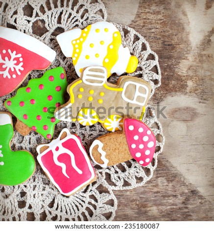 Homemade christmas painted gingerbreads on the wooden background. Selective focus and place for text. Toned 