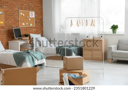 Cardboard boxes in dorm room on moving day
