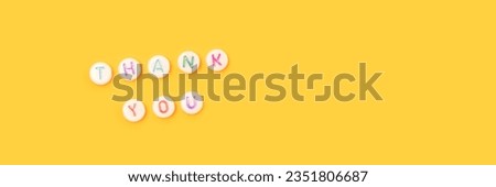 Thank you. Banner with quote made of beads with letters on a yellow background. 