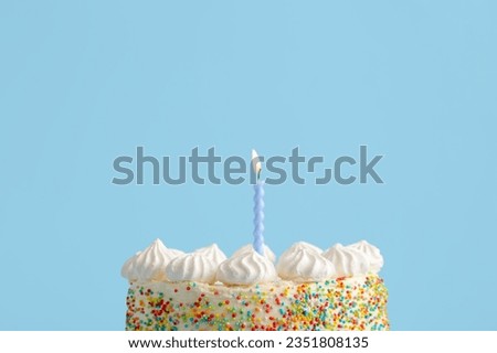 Yummy Birthday cake with candle on blue background