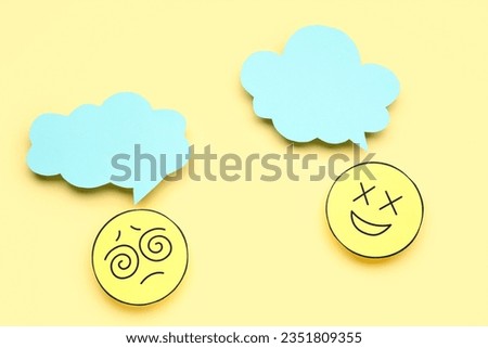 Paper faces with blank speech bubbles on yellow background