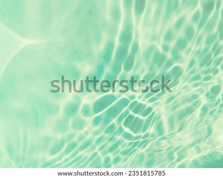 Reflection​ of surface​ blue​ water​ in​ the​ sea. Abstract​ of​ surface​ blue​ water​ for​ background. Closeup​ abstract​ of​ surface​ blue​ water. Splash​ed​ water​ in the​ sea​ for​ background.
