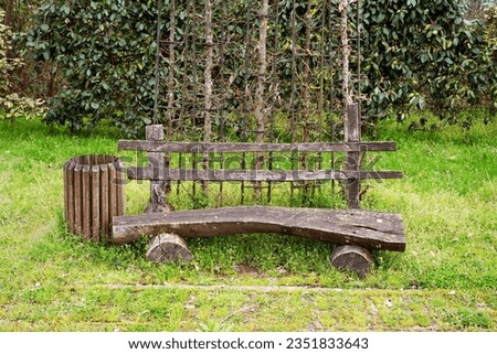 An old wooden bench in a spring park for walking and relaxing