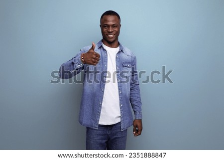 handsome confident young attractive african man dressed casually in denim on background with copy space