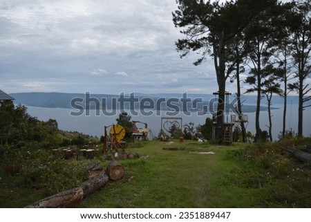 Photo of an outdoor playground that is being built with a backdrop of Lake Toba