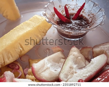 Detox your life by eating fruits, pieces of fresh guava and pineapple with salad and chili sauce dipping