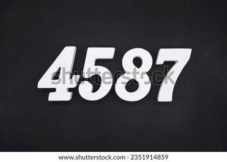Black for the background. The number 4587 is made of white painted wood.