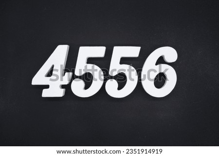 Black for the background. The number 4556 is made of white painted wood.