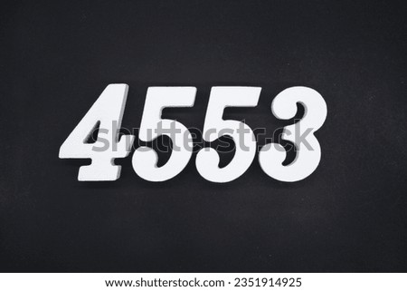 Black for the background. The number 4553 is made of white painted wood.