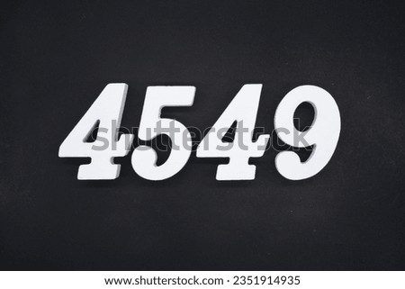 Black for the background. The number 4549 is made of white painted wood.