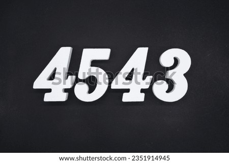 Black for the background. The number 4543 is made of white painted wood.