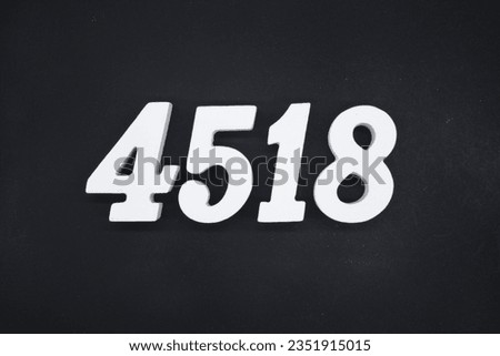 Black for the background. The number 4518 is made of white painted wood.