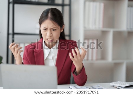 Asian businesswoman feeling stressed while doing paperwork in office