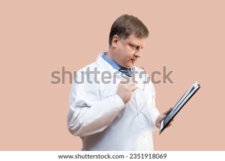 doctor examines X-ray picture, doctor blond 40-44 years old. Royalty-Free Stock Photo #2351918069